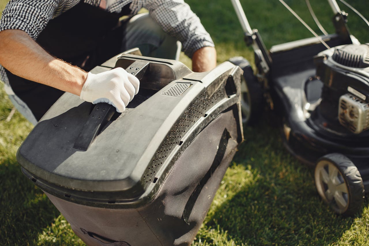 Mastering the First Impression: Your intriguing post title goes here An adult man replacing a lawn mower bag on a sunny day in the yard.